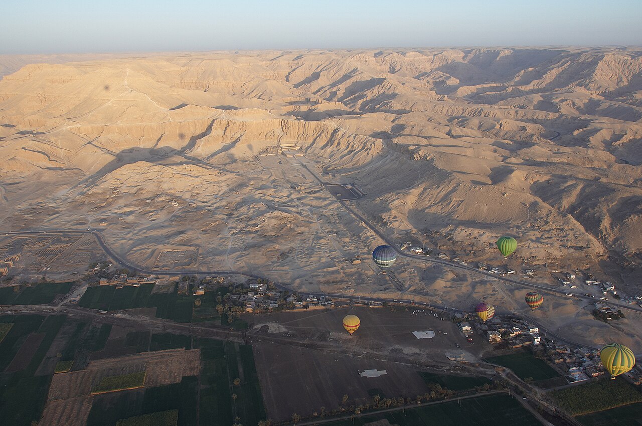 Aerial view of balloons, temples, and desert valleys on Luxor's West Bank